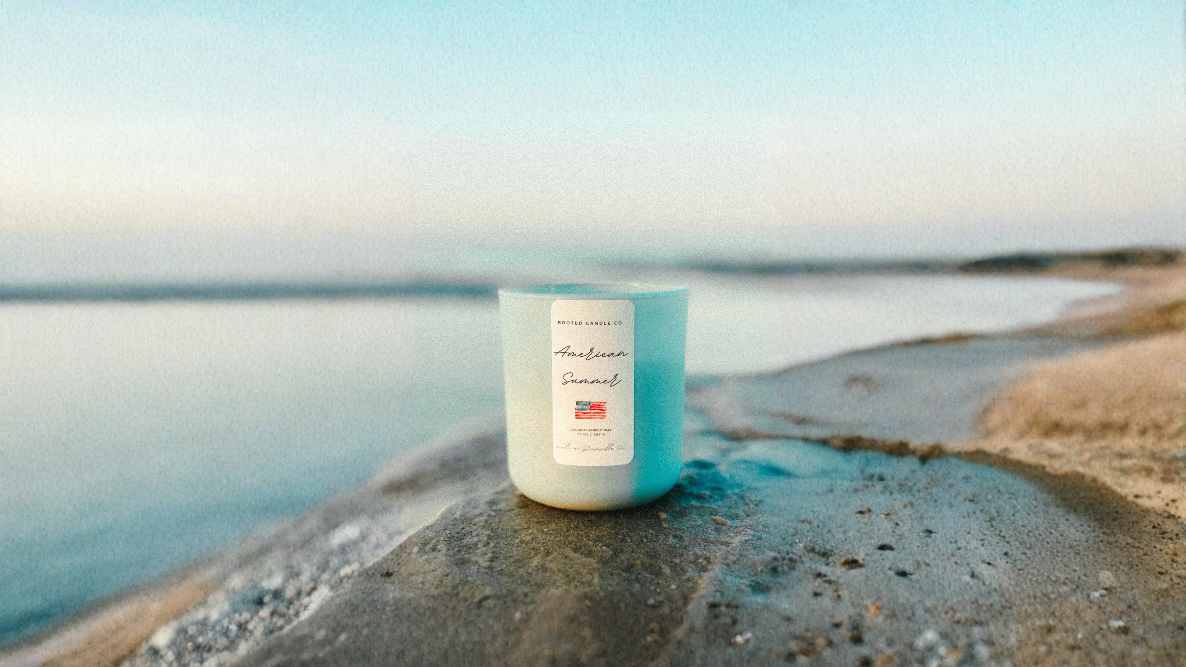 An American Summer candle on the beach at sunset