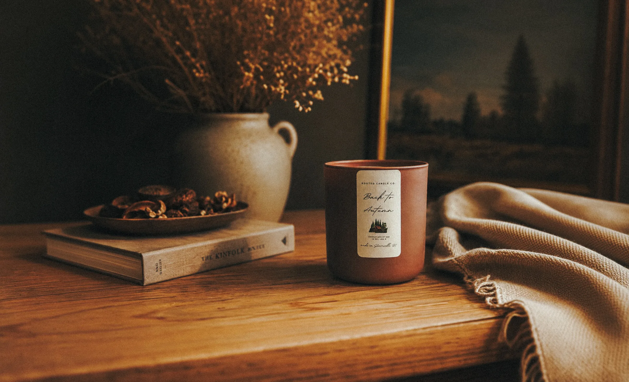 Back to Autumn candle on a wooden table with knit throw and dried florals