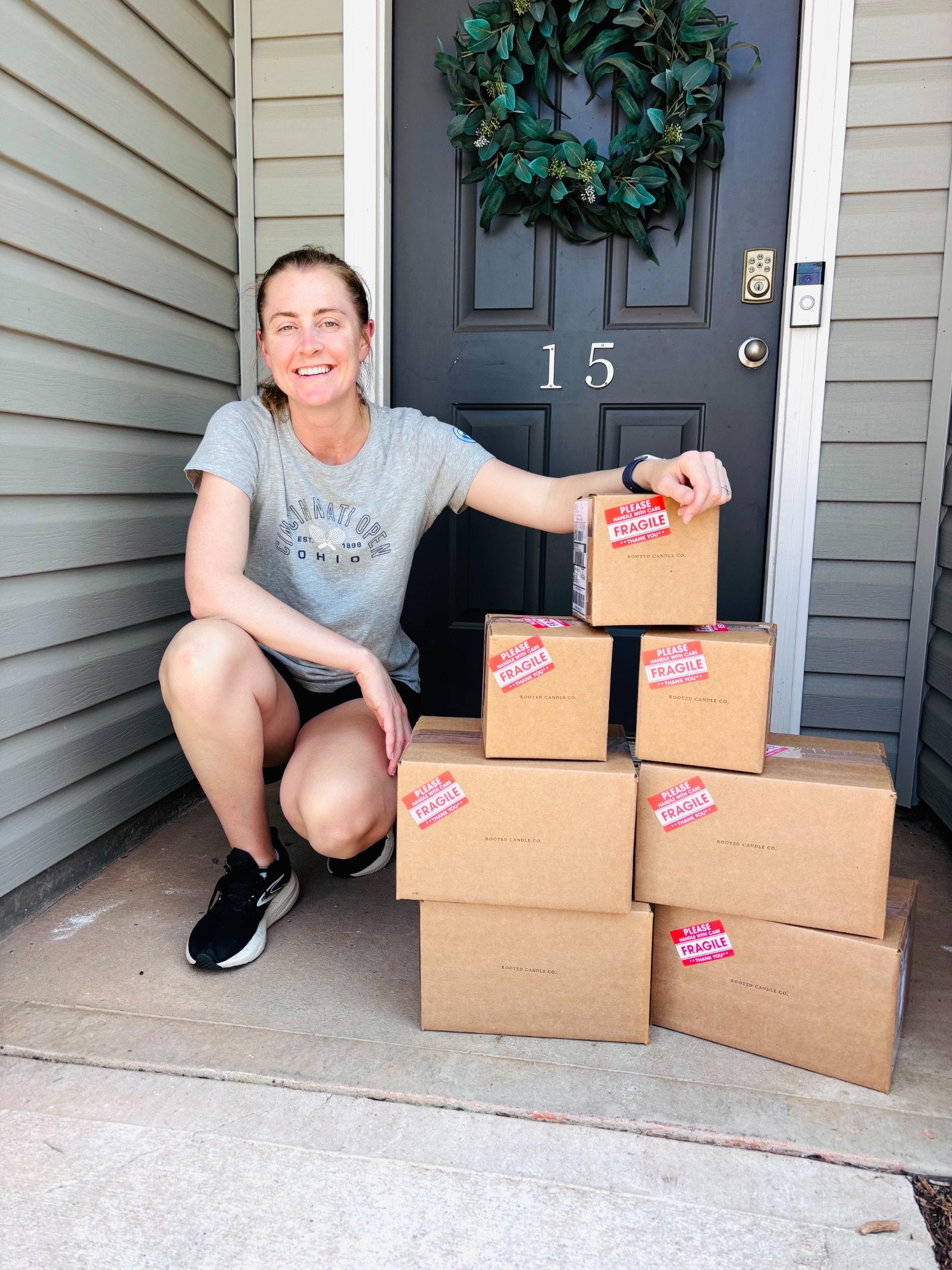 Tracy, founder of Rooted Candle Co., packing orders